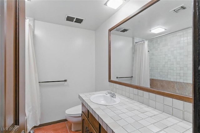 bathroom with toilet, visible vents, and vanity