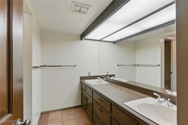 full bathroom with baseboards, visible vents, a sink, and double vanity