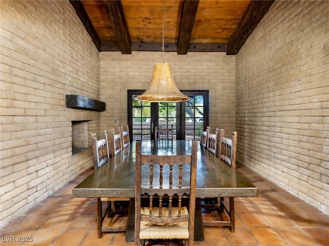 dining area with brick wall, beam ceiling, and wooden ceiling