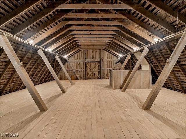 unfinished attic featuring an upstairs landing