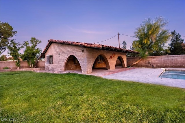view of front facade with a fenced in pool, a tiled roof, a patio, a front lawn, and a fenced backyard