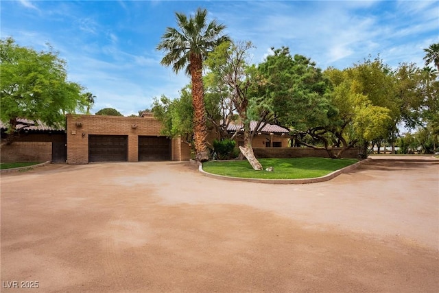 view of front of home featuring concrete driveway and a front yard