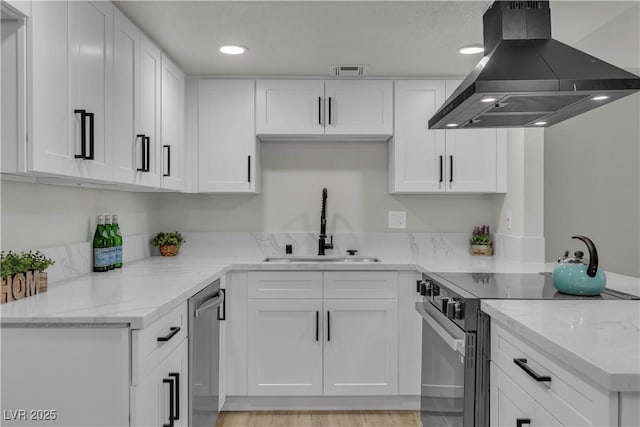 kitchen with dishwasher, a sink, electric stove, island range hood, and white cabinets