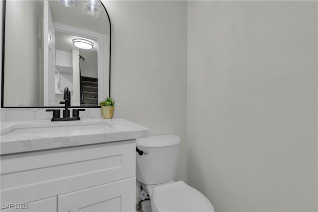 bathroom featuring toilet and vanity