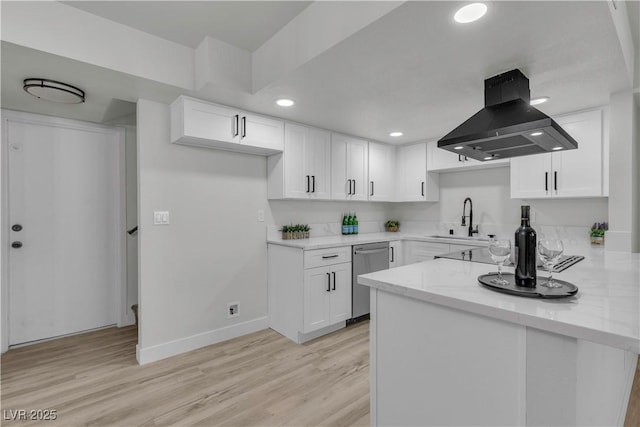 kitchen featuring stainless steel dishwasher, baseboards, a sink, island range hood, and white cabinets