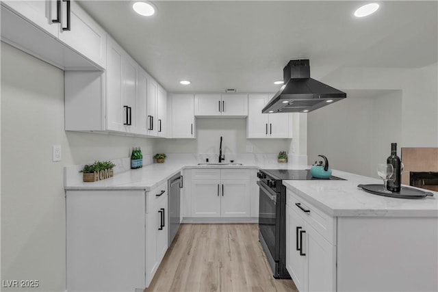 kitchen featuring exhaust hood, stainless steel dishwasher, a sink, a peninsula, and black electric range