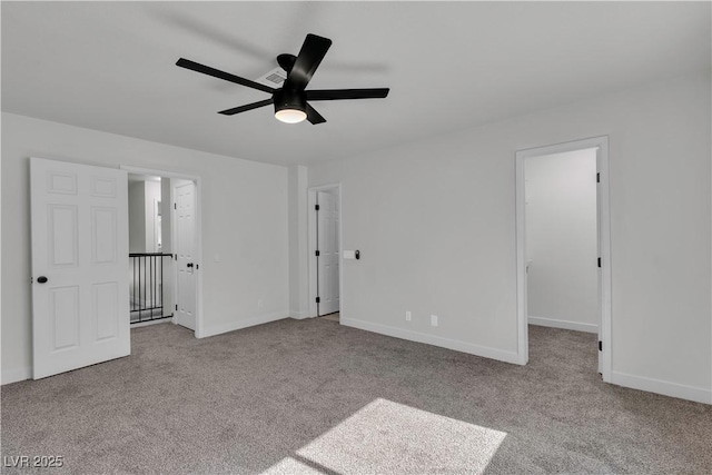 unfurnished bedroom featuring baseboards, a spacious closet, and carpet floors