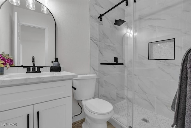 full bathroom featuring vanity, toilet, and a shower stall