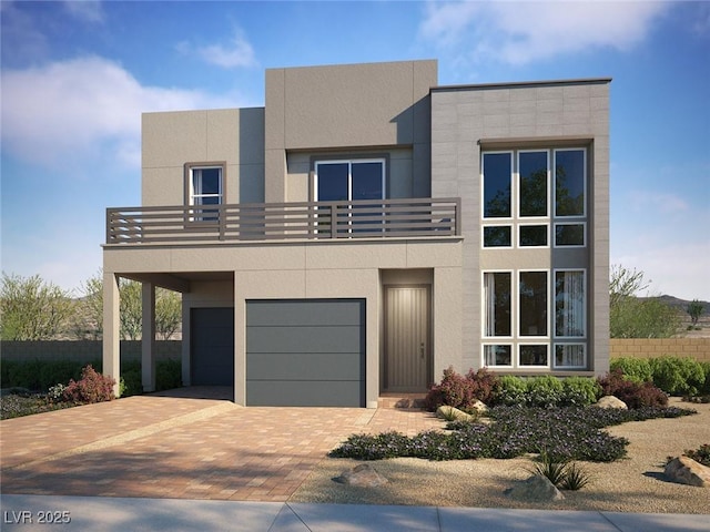 1801 Flycatch St, Las Vegas, NV 89138 - view of front facade with an attached garage, stucco siding, decorative driveway, and a balcony