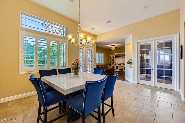 dining room featuring french doors, a chandelier, baseboards, and light tile patterned flooring