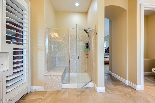 ensuite bathroom with a shower stall, tile patterned floors, toilet, recessed lighting, and baseboards