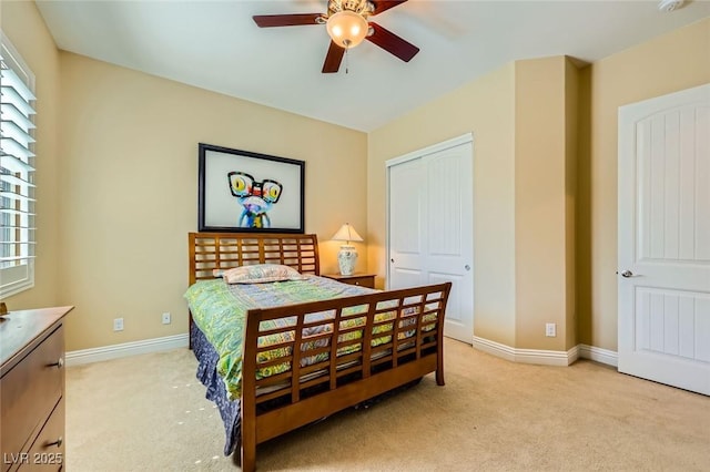 bedroom featuring light colored carpet, a closet, and multiple windows