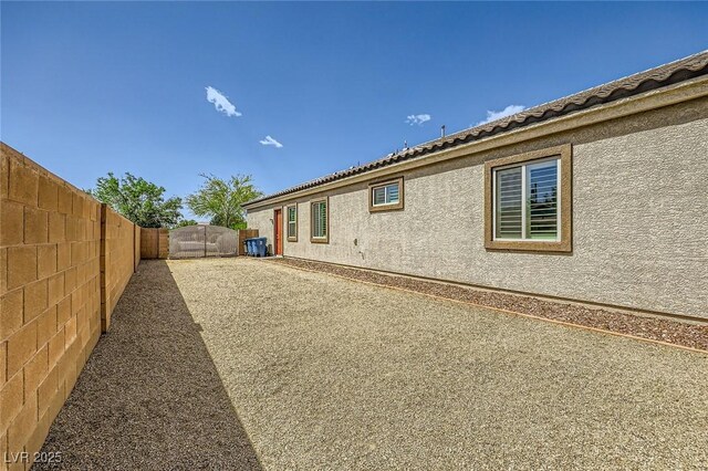 view of home's exterior featuring fence and stucco siding