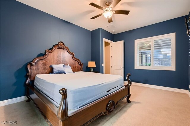 carpeted bedroom featuring baseboards and a ceiling fan