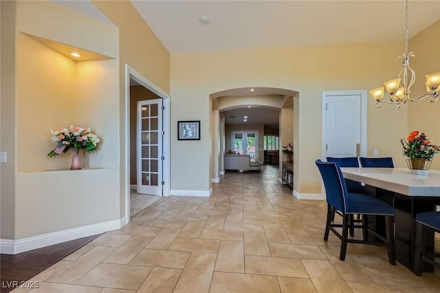 7418 Lawrence Powers Ct, Las Vegas, NV 89129 - dining area with a chandelier, arched walkways, baseboards, and recessed lighting