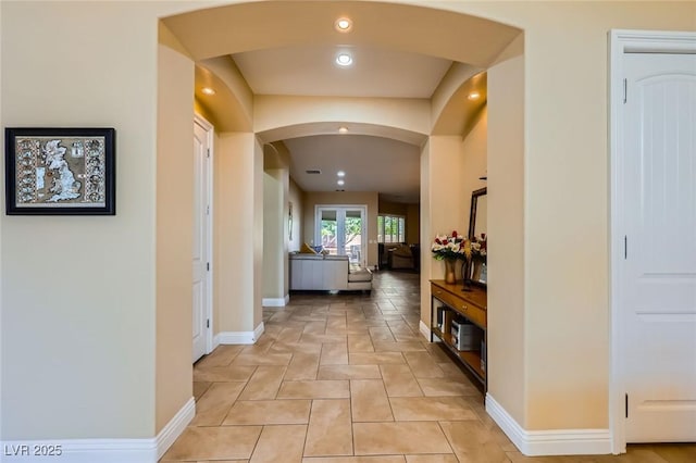 7418 Lawrence Powers Ct, Las Vegas, NV 89129 - corridor featuring arched walkways, baseboards, recessed lighting, and light stone finish flooring