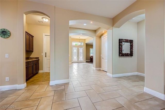 7418 Lawrence Powers Ct, Las Vegas, NV 89129 - hall with arched walkways, baseboards, recessed lighting, and light tile patterned flooring