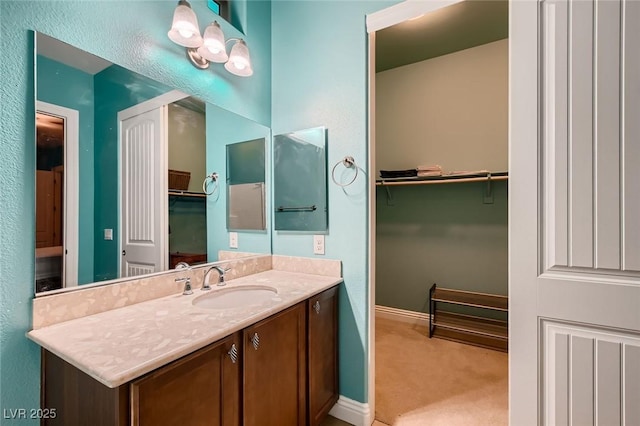 7418 Lawrence Powers Ct, Las Vegas, NV 89129 - bathroom featuring vanity, a spacious closet, and baseboards