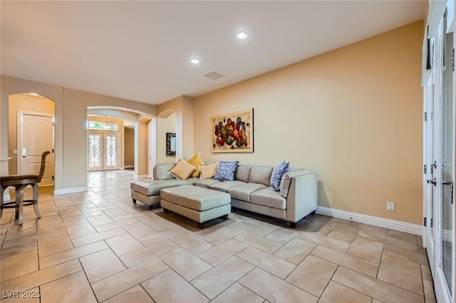 7418 Lawrence Powers Ct, Las Vegas, NV 89129 - living room with arched walkways, french doors, recessed lighting, baseboards, and light tile patterned flooring