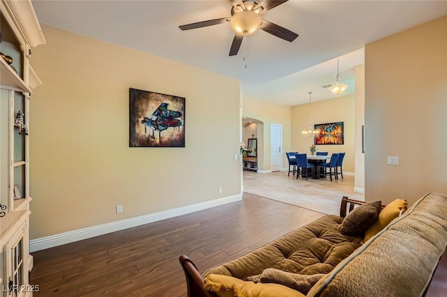 7418 Lawrence Powers Ct, Las Vegas, NV 89129 - living area with arched walkways, wood finished floors, ceiling fan, a chandelier, and baseboards