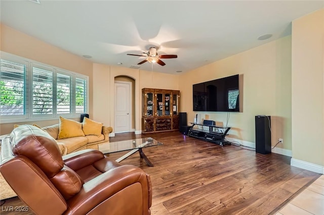 7418 Lawrence Powers Ct, Las Vegas, NV 89129 - living room with ceiling fan, wood finished floors, baseboards, and arched walkways