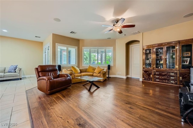7418 Lawrence Powers Ct, Las Vegas, NV 89129 - living area with ceiling fan, arched walkways, baseboards, and wood finished floors