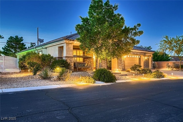 7418 Lawrence Powers Ct, Las Vegas, NV 89129 - view of front of home with a garage, a tiled roof, stucco siding, and stone siding