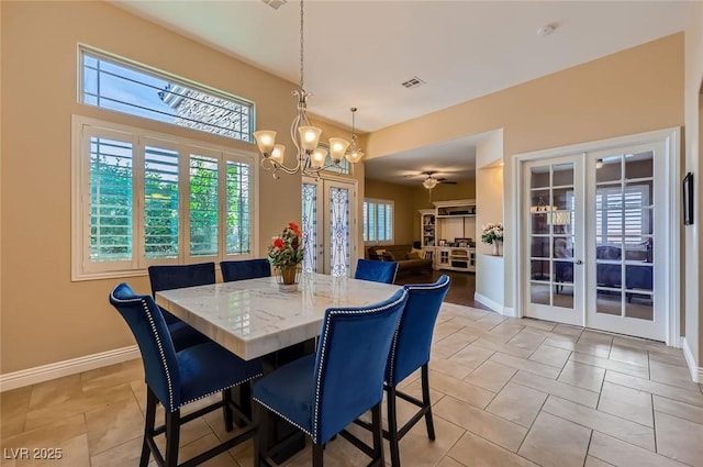 7418 Lawrence Powers Ct, Las Vegas, NV 89129 - dining space featuring french doors, a chandelier, baseboards, and light tile patterned floors