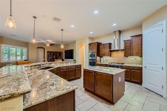 7418 Lawrence Powers Ct, Las Vegas, NV 89129 - kitchen with wall chimney range hood, a large island with sink, appliances with stainless steel finishes, a sink, and decorative backsplash