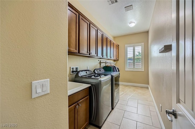 7418 Lawrence Powers Ct, Las Vegas, NV 89129 - washroom featuring washer and clothes dryer, cabinet space, a textured ceiling, baseboards, and a textured wall