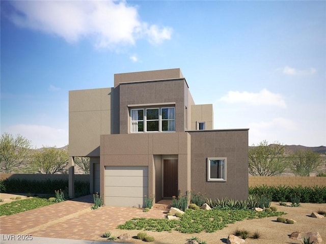 1790 Flycatch St, Las Vegas, NV 89138 - view of front facade with an attached garage, stucco siding, and decorative driveway