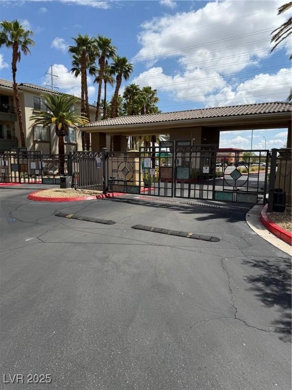 view of car parking with a gate and fence