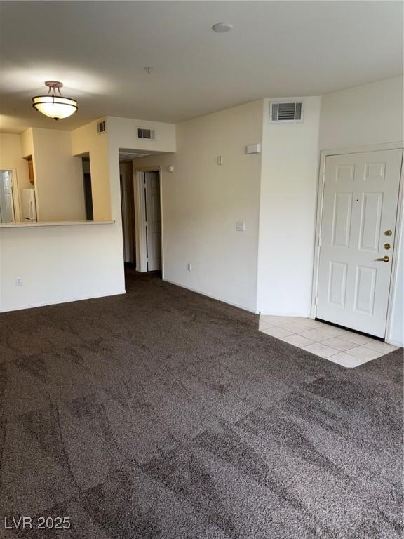 unfurnished living room with visible vents and carpet floors