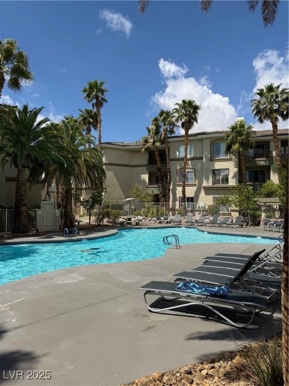 pool featuring a patio and fence