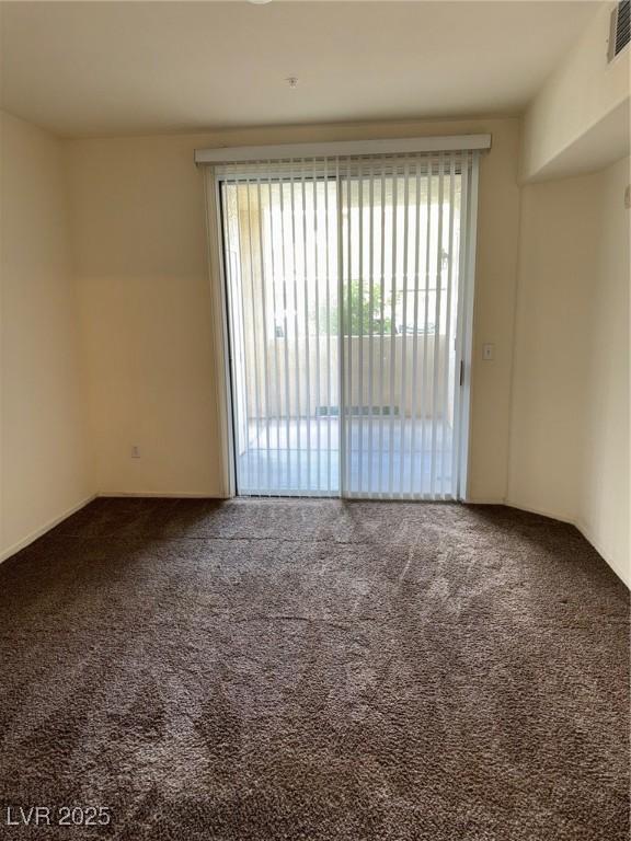 carpeted empty room with a wealth of natural light and visible vents