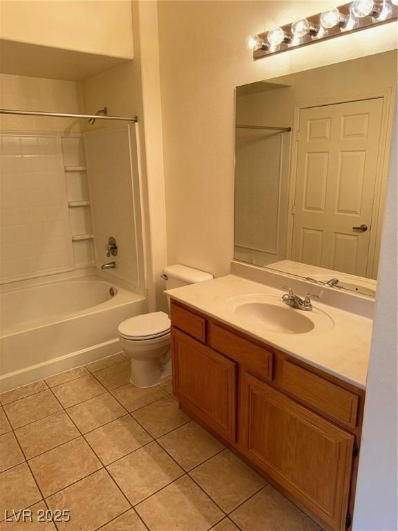 bathroom with vanity, toilet, shower / tub combination, and tile patterned floors