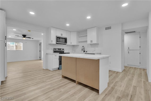 617 Stanford St, Las Vegas, NV 89107 - kitchen featuring white cabinetry, baseboards, visible vents, and appliances with stainless steel finishes