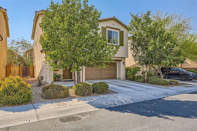 view of front of house with fence, an attached garage, concrete driveway, stucco siding, and a tiled roof