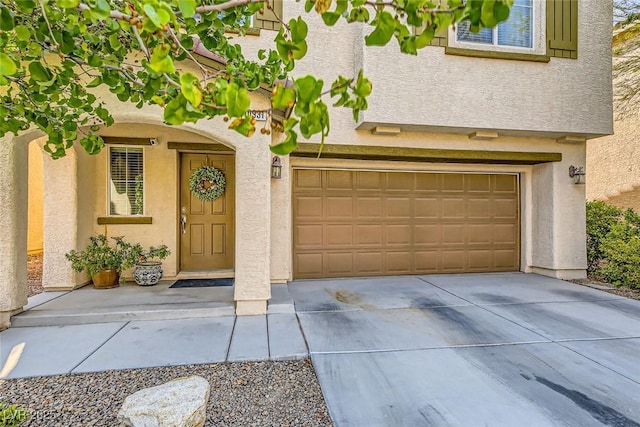 exterior space with driveway, stucco siding, and a garage
