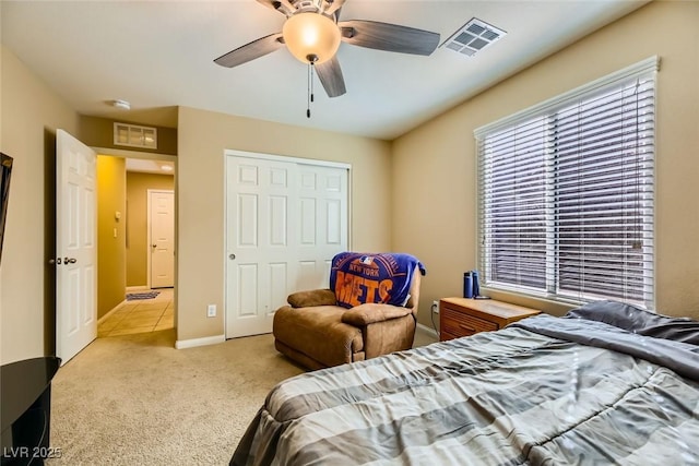 bedroom featuring a ceiling fan, a closet, visible vents, and carpet floors