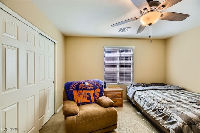 bedroom with light colored carpet, visible vents, and a ceiling fan