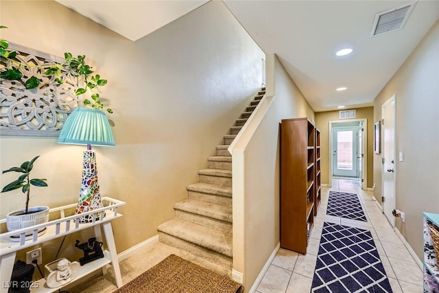 staircase featuring baseboards, recessed lighting, tile patterned flooring, and visible vents