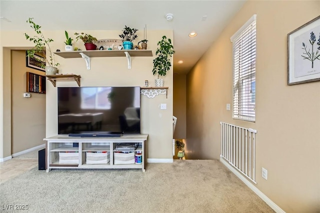 carpeted living room featuring baseboards, radiator heating unit, and recessed lighting