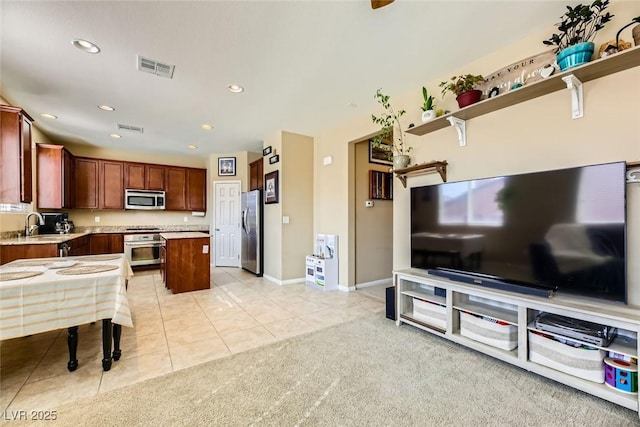 living area with light tile patterned floors, visible vents, and recessed lighting