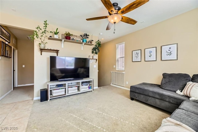carpeted living room with baseboards and ceiling fan