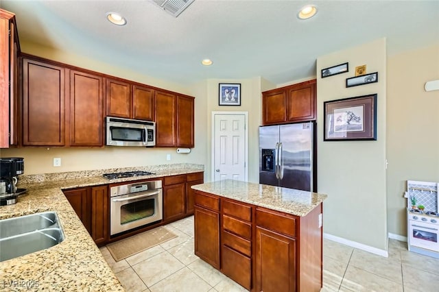 kitchen featuring recessed lighting, a center island, light tile patterned flooring, visible vents, and appliances with stainless steel finishes