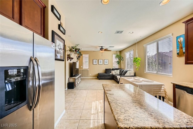 kitchen with recessed lighting, visible vents, light tile patterned flooring, light carpet, and appliances with stainless steel finishes