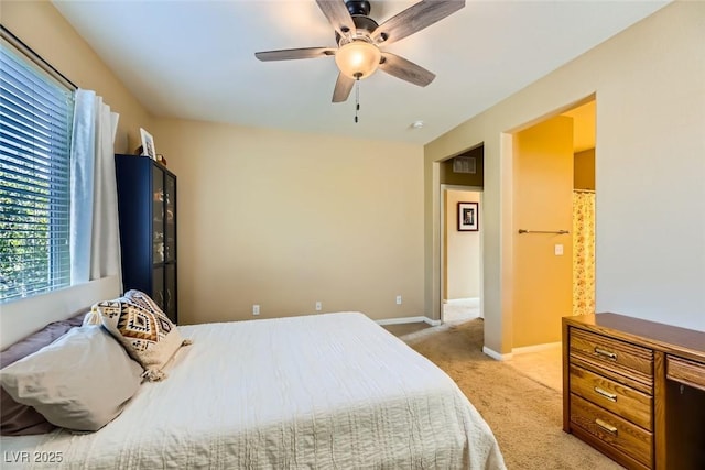 bedroom featuring light carpet, baseboards, and ceiling fan
