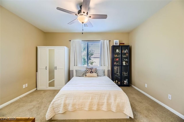 bedroom featuring light carpet, baseboards, and a ceiling fan