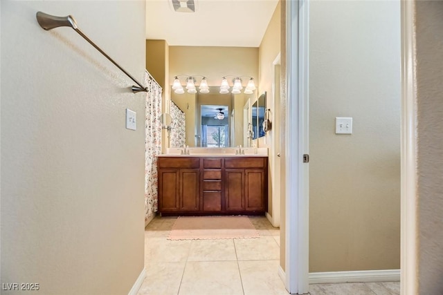 bathroom with tile patterned flooring, double vanity, a sink, and curtained shower